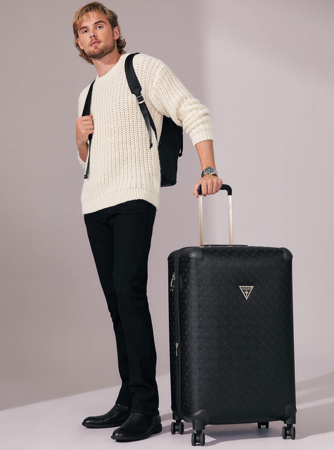 Black Debossed Wilder 71cm Suitcase | GUESS Handbags | model view